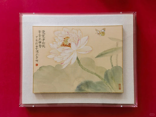 A hand-painted ink painting of a white lotus with butterflies and Chinese characters
